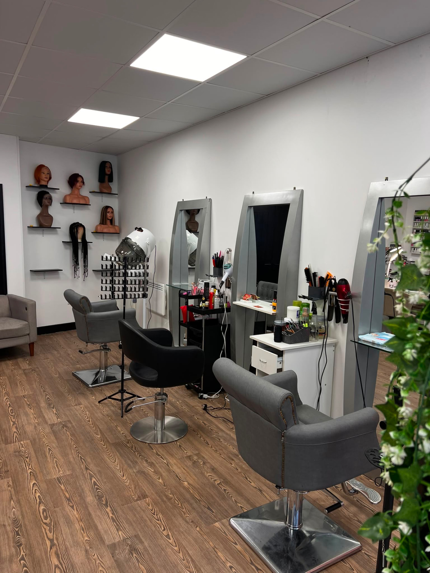 Real wig displays and styling stations inside Montana Beauty Empire